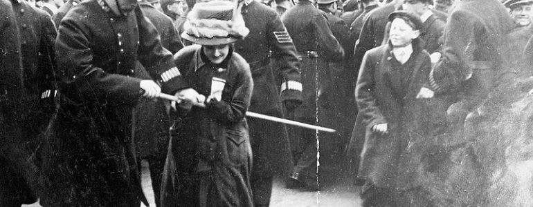 Black Friday, 18 November 1910: A policeman attempts to seize the banner pole of a suffrage demonstrator. (Daily Mirror, Wikimedia Commons)