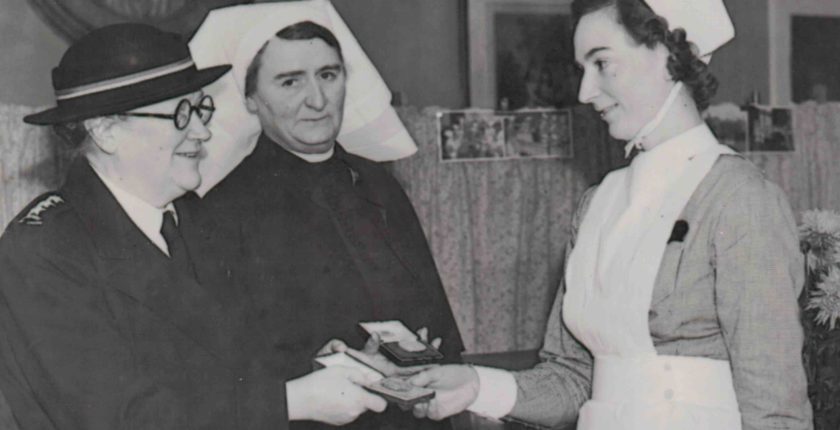 Doris Miles receives her Gold Medal for Excellence in Nursing from Ruth Derbyshire, British Red Cross, while St. Mary’s matron Mary Milne looks on. (Jill Rose)